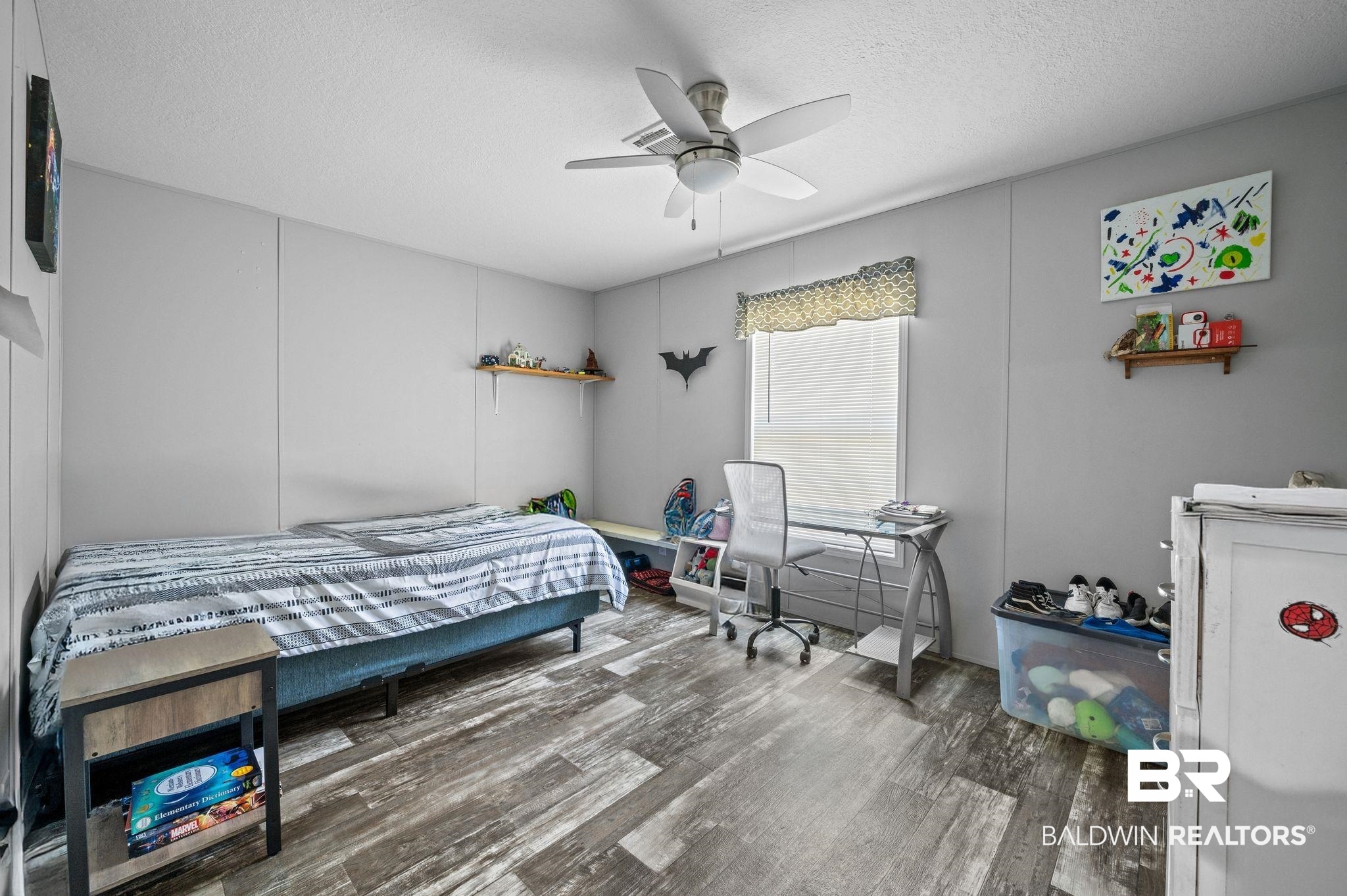 9382 D'Olive Street Bay Minette, AL 36507 - Photo 13 of 27 Bedroom with hardwood / wood-style flooring, ceiling fan, and a textured ceiling