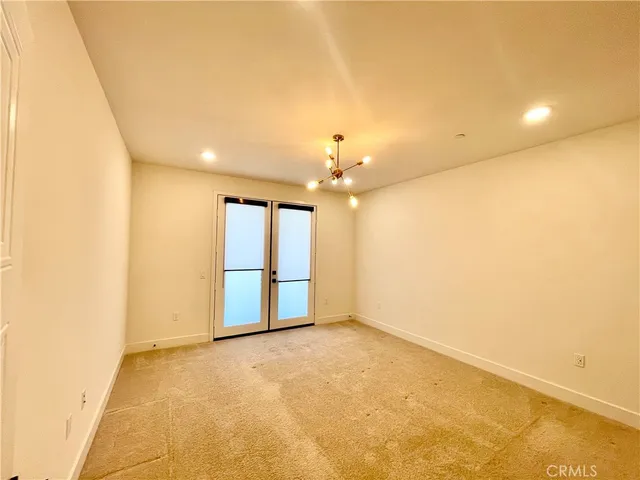 an empty room with a empty space and a ceiling fan