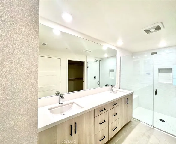 a bathroom with a double vanity sink mirror and double