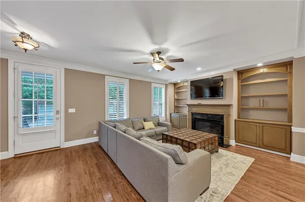 a living room with furniture a fireplace and a flat screen tv