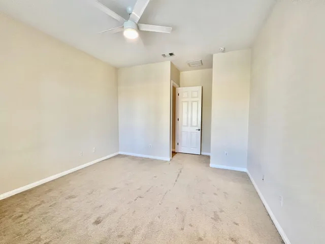 an empty room with windows and closet