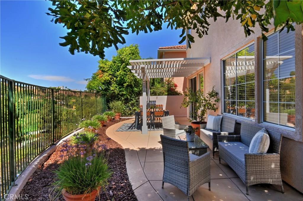 3619 Cll Joaquin Calabasas, CA 91302 - Photo 15 of 42 a view of a patio with couches table and chairs and potted plants