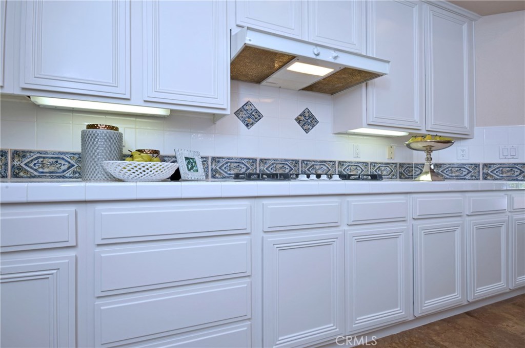 3619 Cll Joaquin Calabasas, CA 91302 - Photo 26 of 42 a kitchen with white cabinets and a sink