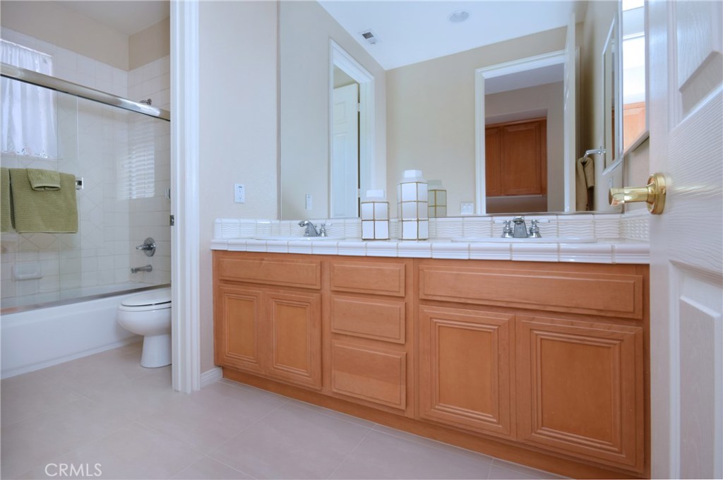3619 Cll Joaquin Calabasas, CA 91302 - Photo 30 of 42 a bathroom with a granite countertop sink mirror vanity and toilet