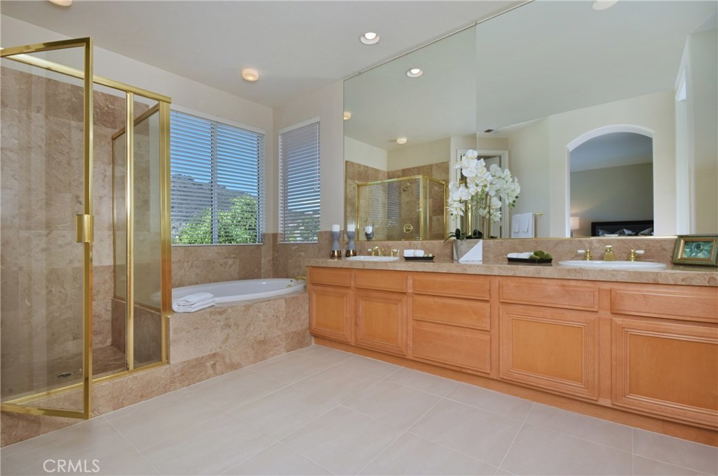 3619 Cll Joaquin Calabasas, CA 91302 - Photo 38 of 42 a bathroom with a granite countertop sink mirror and bathtub