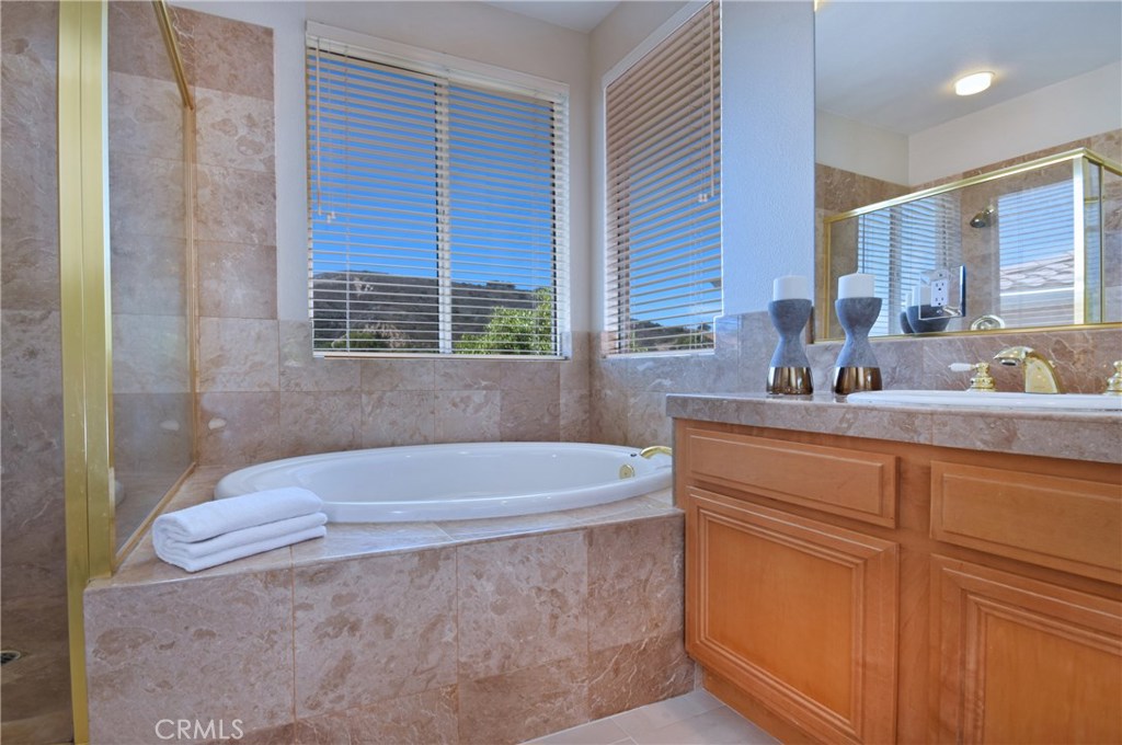 3619 Cll Joaquin Calabasas, CA 91302 - Photo 39 of 42 a bathroom with a tub sink and mirror