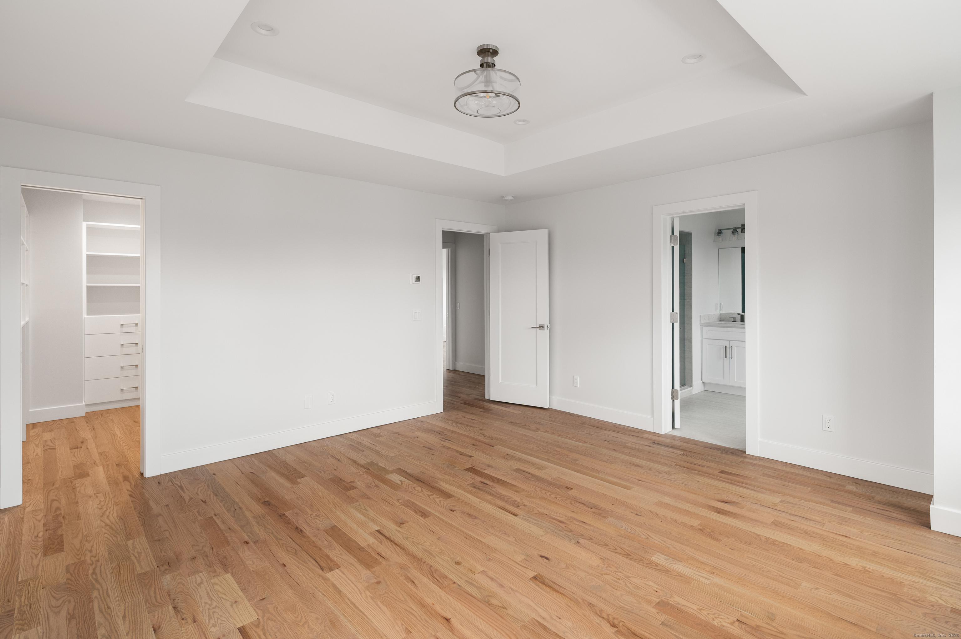 12 Walnut Ridge Court Stamford, CT 06905 - Photo 15 of 32 a view of an empty room with wooden floor and windows