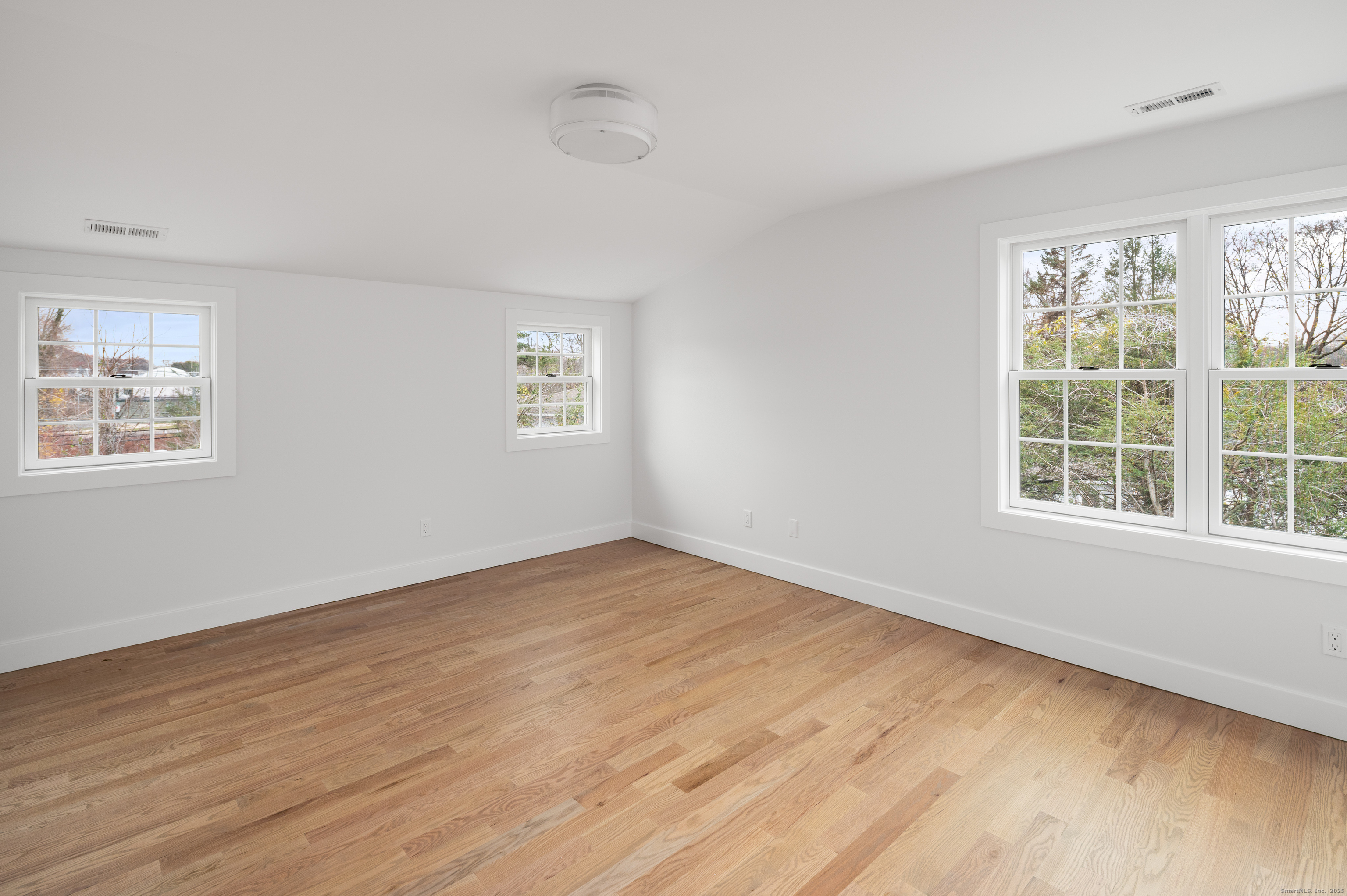 12 Walnut Ridge Court Stamford, CT 06905 - Photo 21 of 32 a view of an empty room with wooden floor and a window