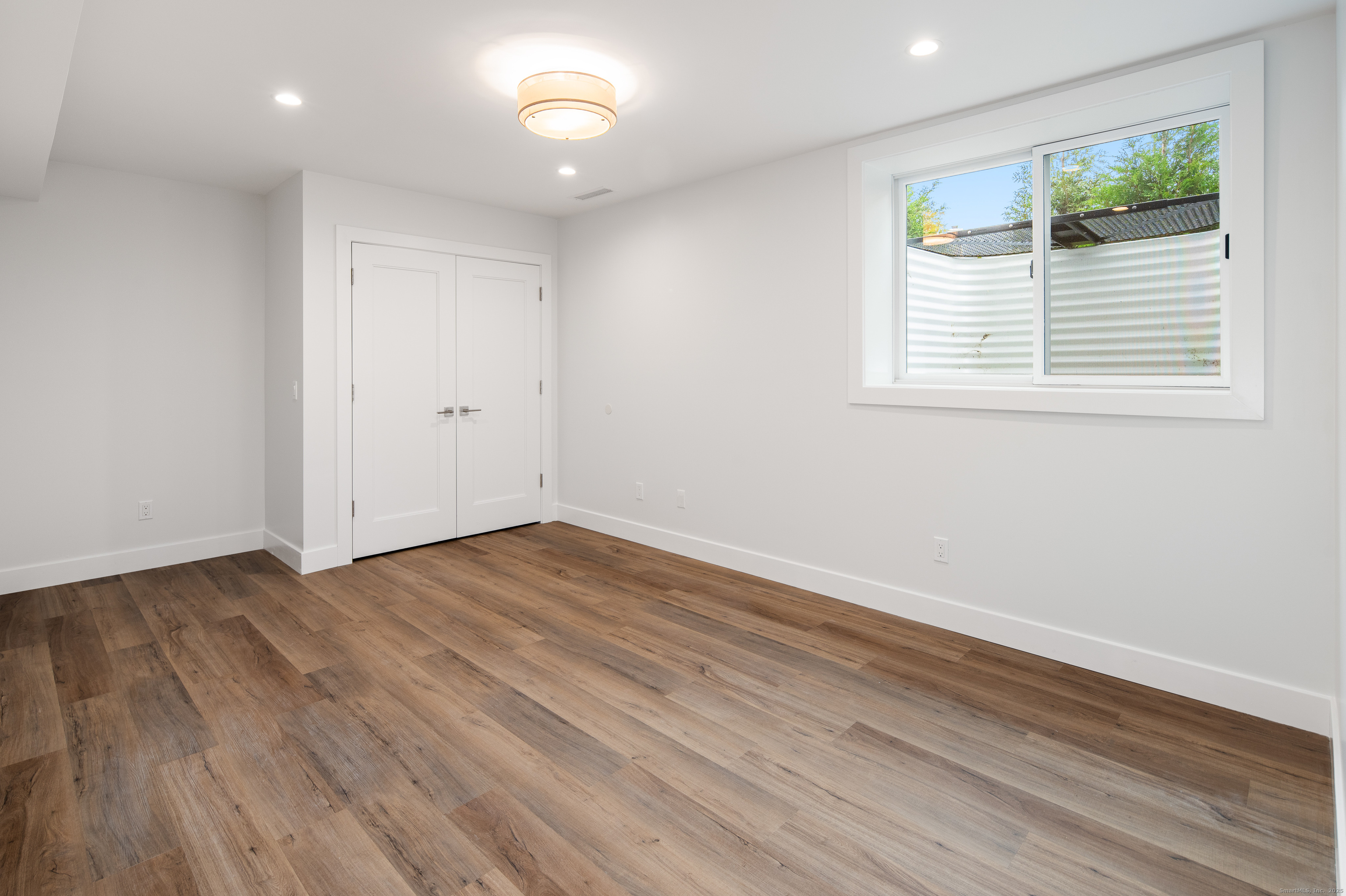 12 Walnut Ridge Court Stamford, CT 06905 - Photo 23 of 32 an empty room with wooden floor and windows