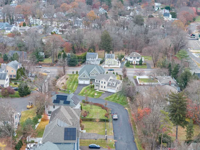 an aerial view of a house with garden space and street view