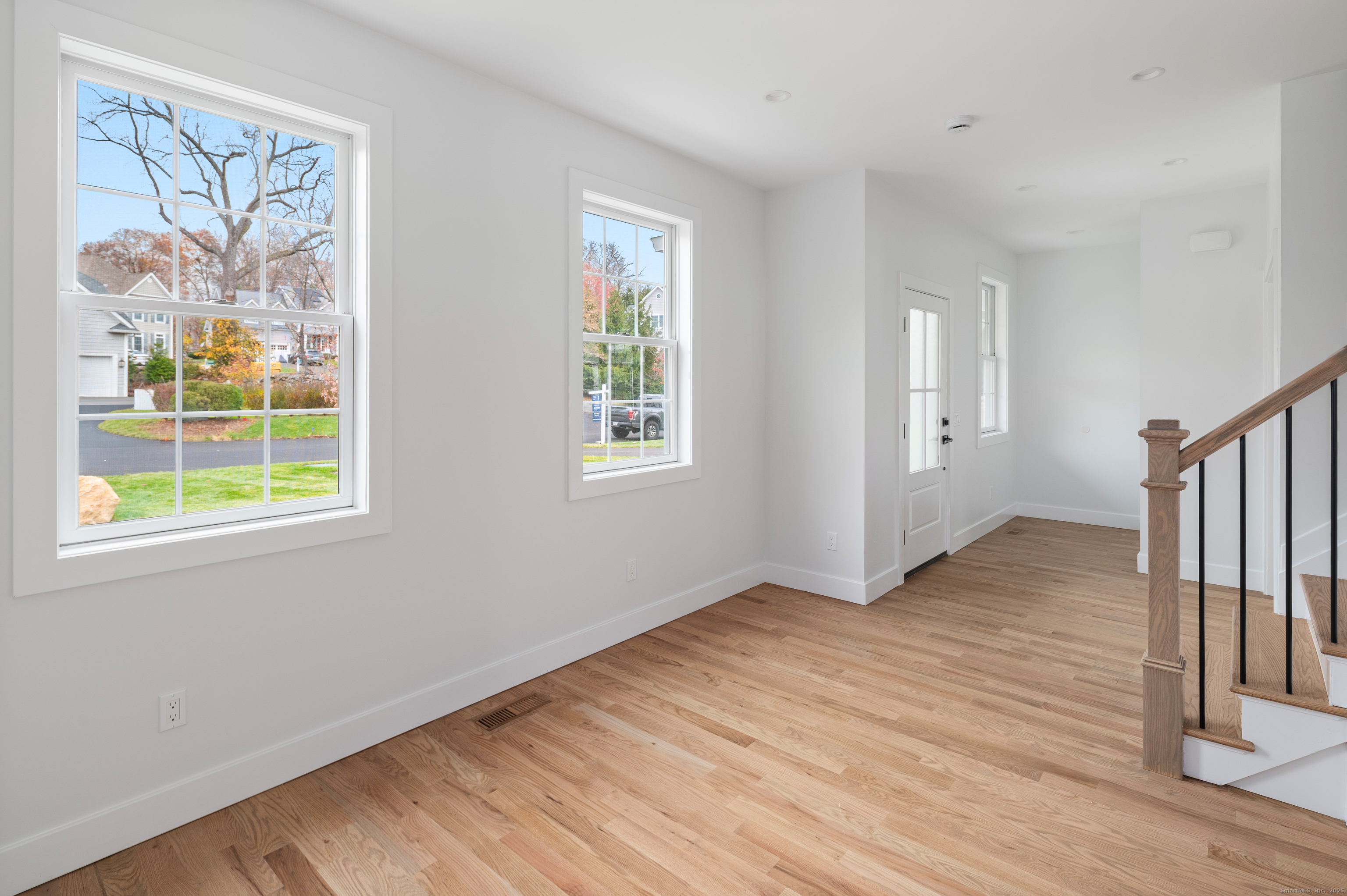 12 Walnut Ridge Court Stamford, CT 06905 - Photo 3 of 32 a view of an empty room with wooden floor and a window