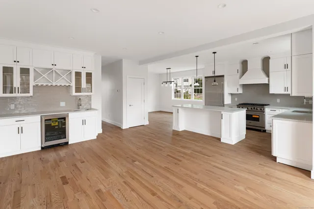 a kitchen with stainless steel appliances a white cabinets and stove top oven