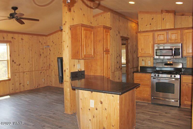 8 County Road 8309 Concho, AZ 85924 - Photo 13 of 45 a kitchen with stainless steel appliances granite countertop a sink a stove and a refrigerator