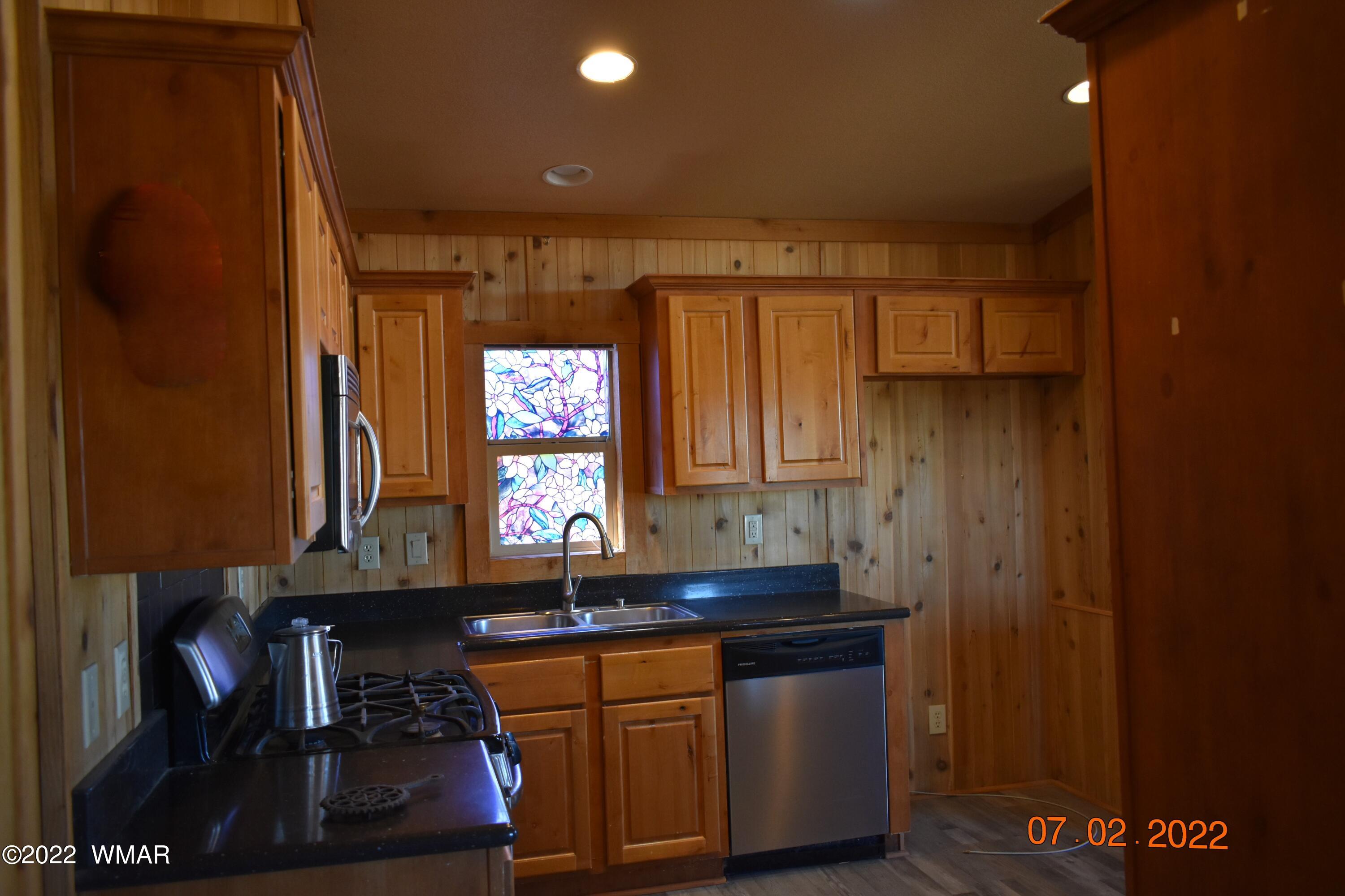 8 County Road 8309 Concho, AZ 85924 - Photo 16 of 45 a kitchen with stainless steel appliances granite countertop a sink and a stove