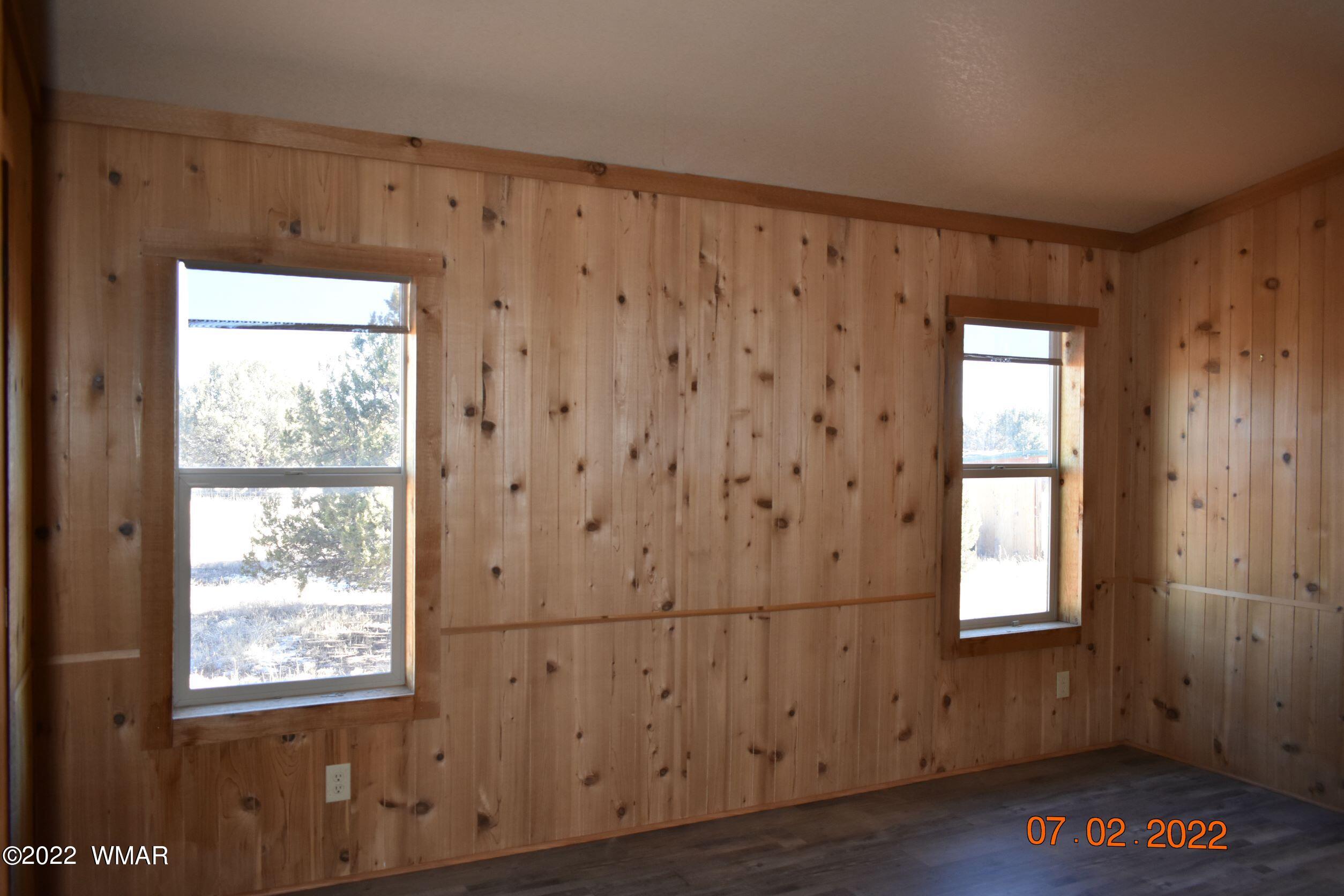 8 County Road 8309 Concho, AZ 85924 - Photo 18 of 45 a view of an empty room with wooden floor and a window