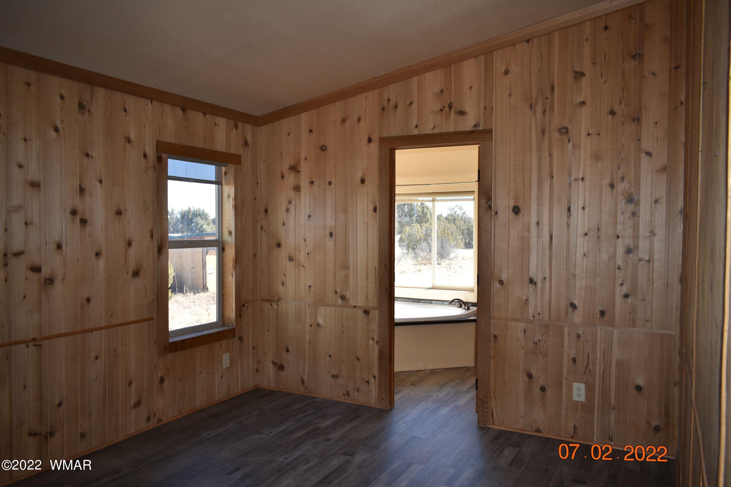 8 County Road 8309 Concho, AZ 85924 - Photo 20 of 45 a view of an empty room with wooden floor and a window