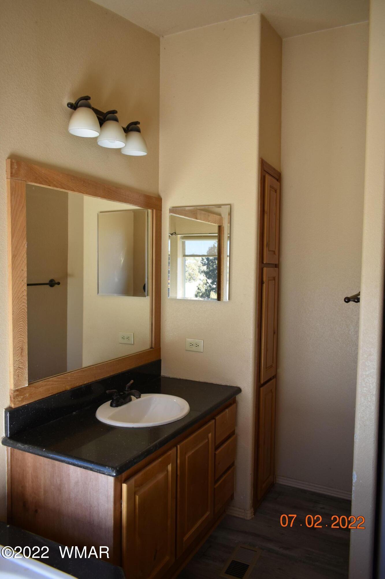 8 County Road 8309 Concho, AZ 85924 - Photo 22 of 45 a bathroom with a sink a mirror and a toilet