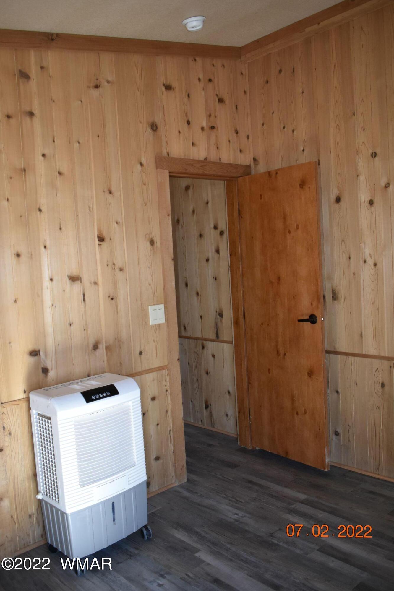 8 County Road 8309 Concho, AZ 85924 - Photo 25 of 45 a room with a furniture and wooden floor