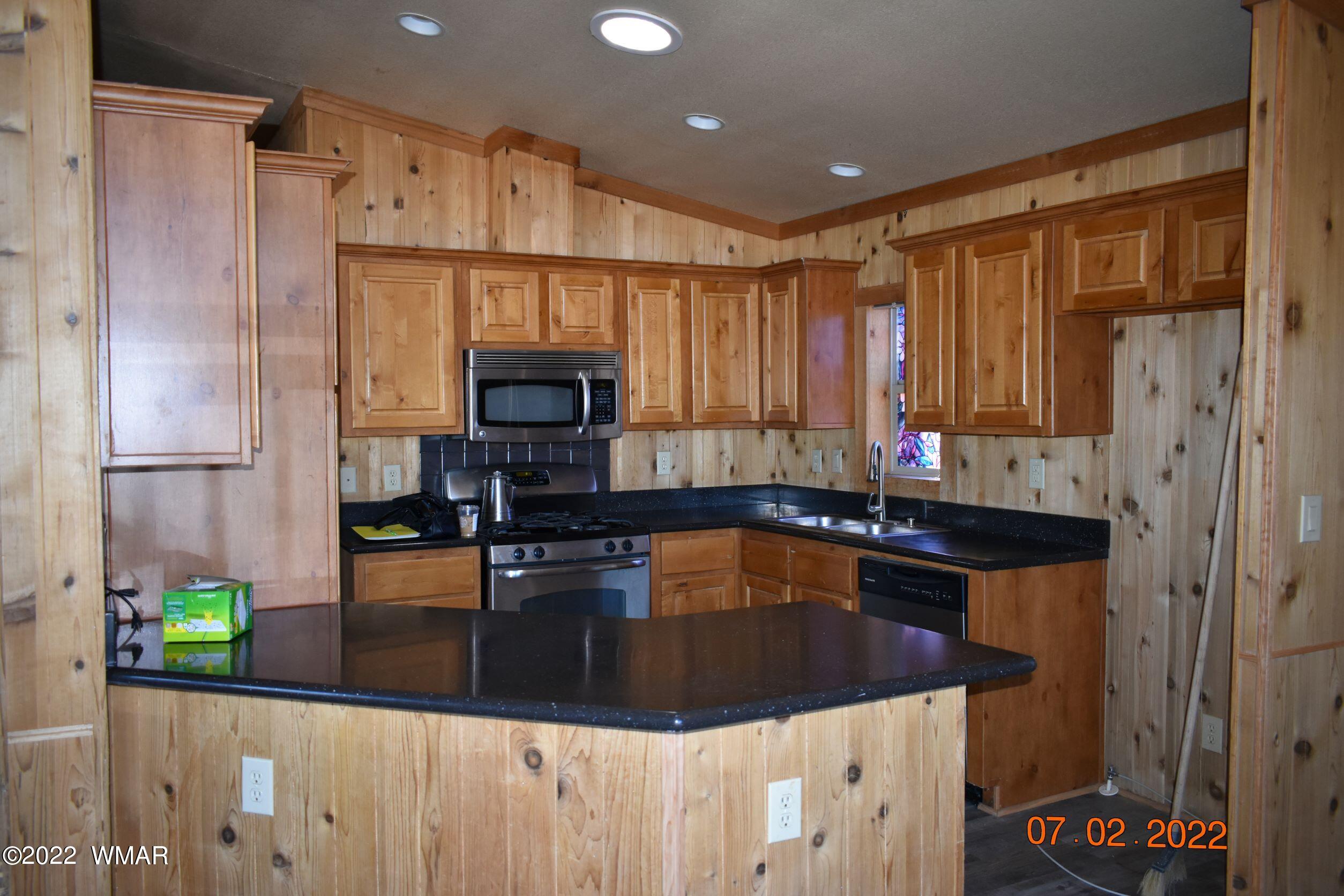 8 County Road 8309 Concho, AZ 85924 - Photo 10 of 45 a kitchen with kitchen island granite countertop a sink a stove and a refrigerator