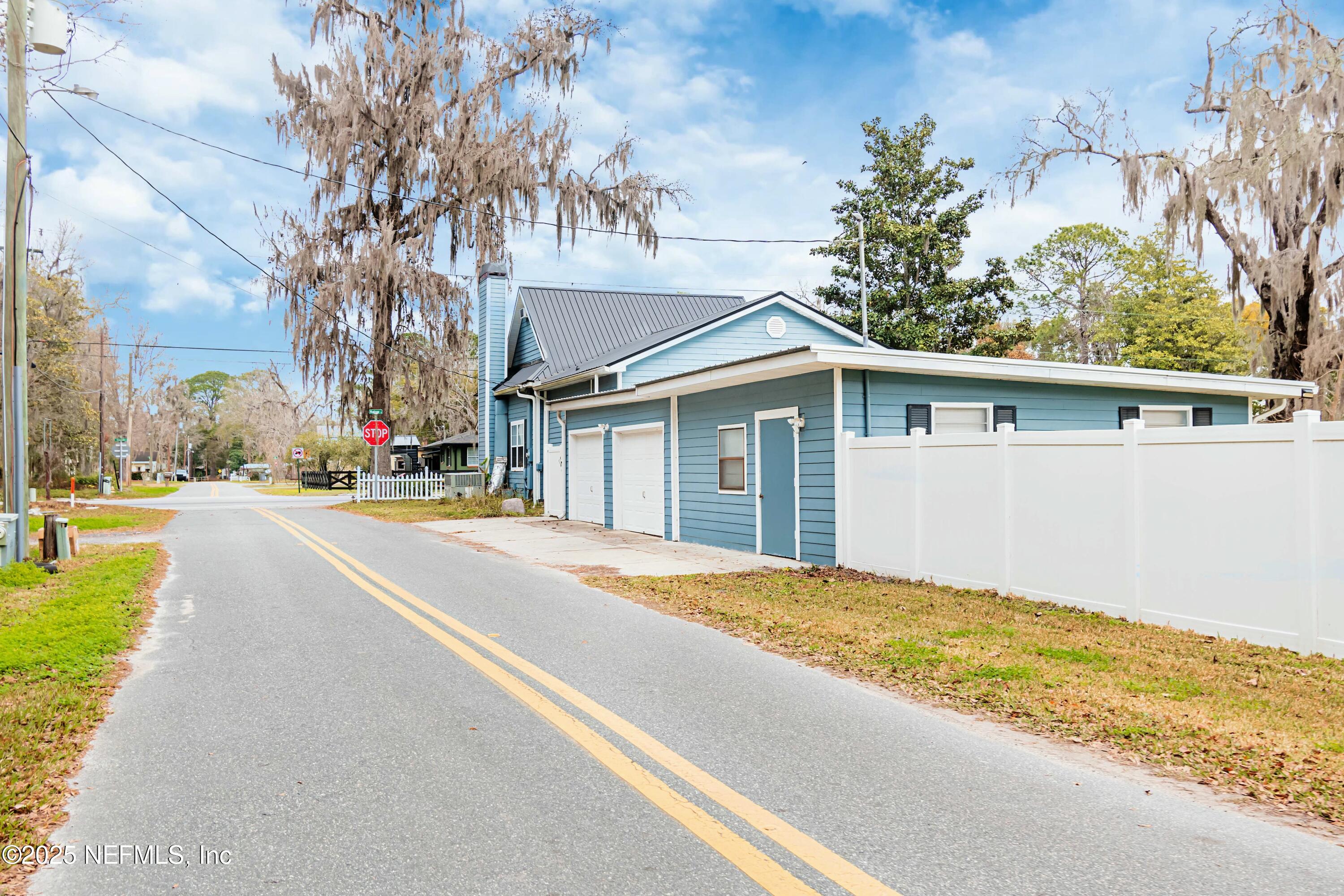 680 West Madison Street Starke, FL 32091 - Photo 19 of 22 a view of house with yard and trees in the background