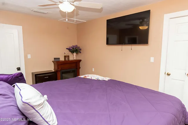 a view of a hallway with workspace and a window