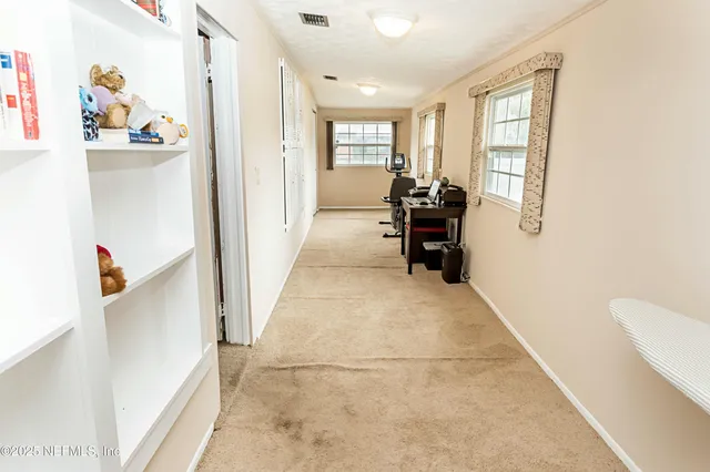 a living room with a flat screen tv and a fireplace