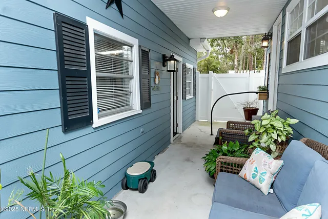 a view of house with yard and trees in the background
