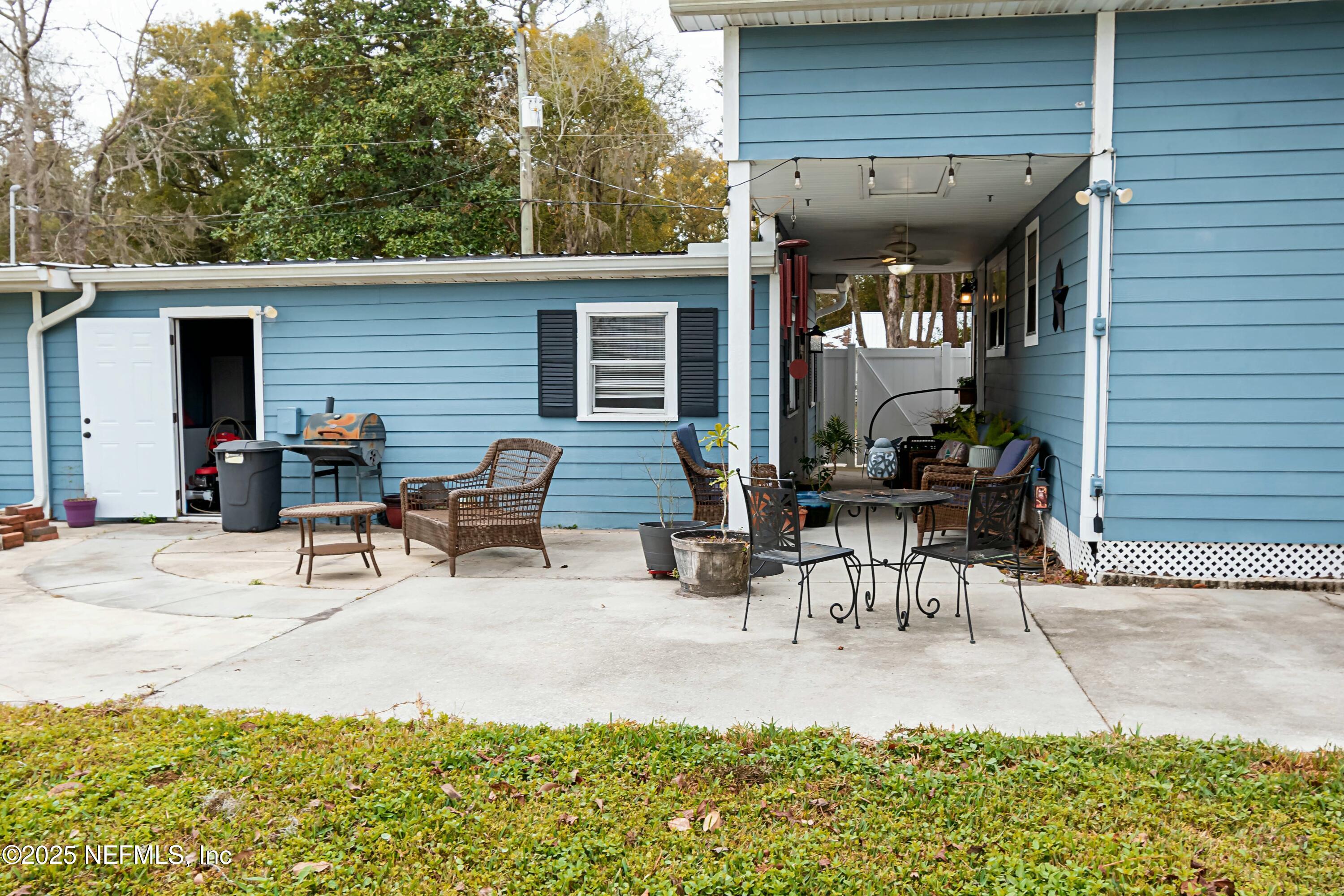 680 West Madison Street Starke, FL 32091 - Photo 6 of 22 a view of a patio with table and chairs with wooden fence