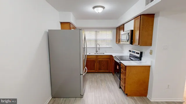 a utility room with two washing machine and a sink