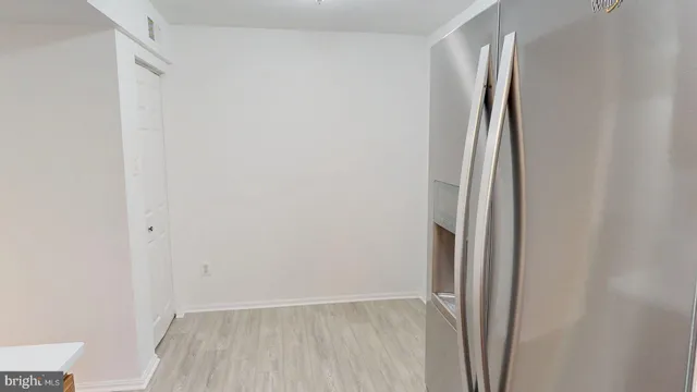 a view of a room with wooden floor and a window