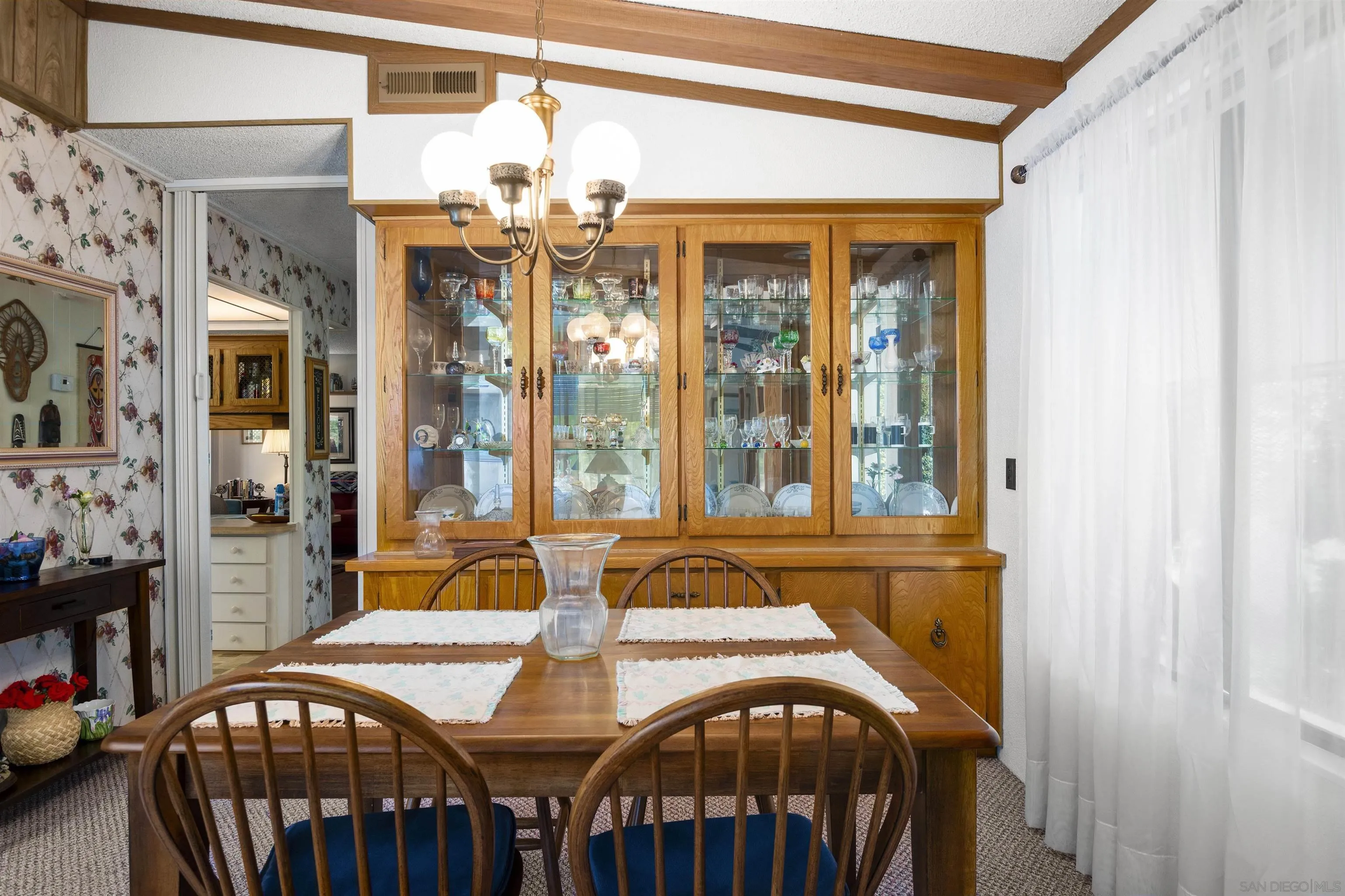 4747 Oak Crest Road, Unit 19 Fallbrook, CA 92028 - Photo 15 of 53 a view of a dining room with furniture and chandelier