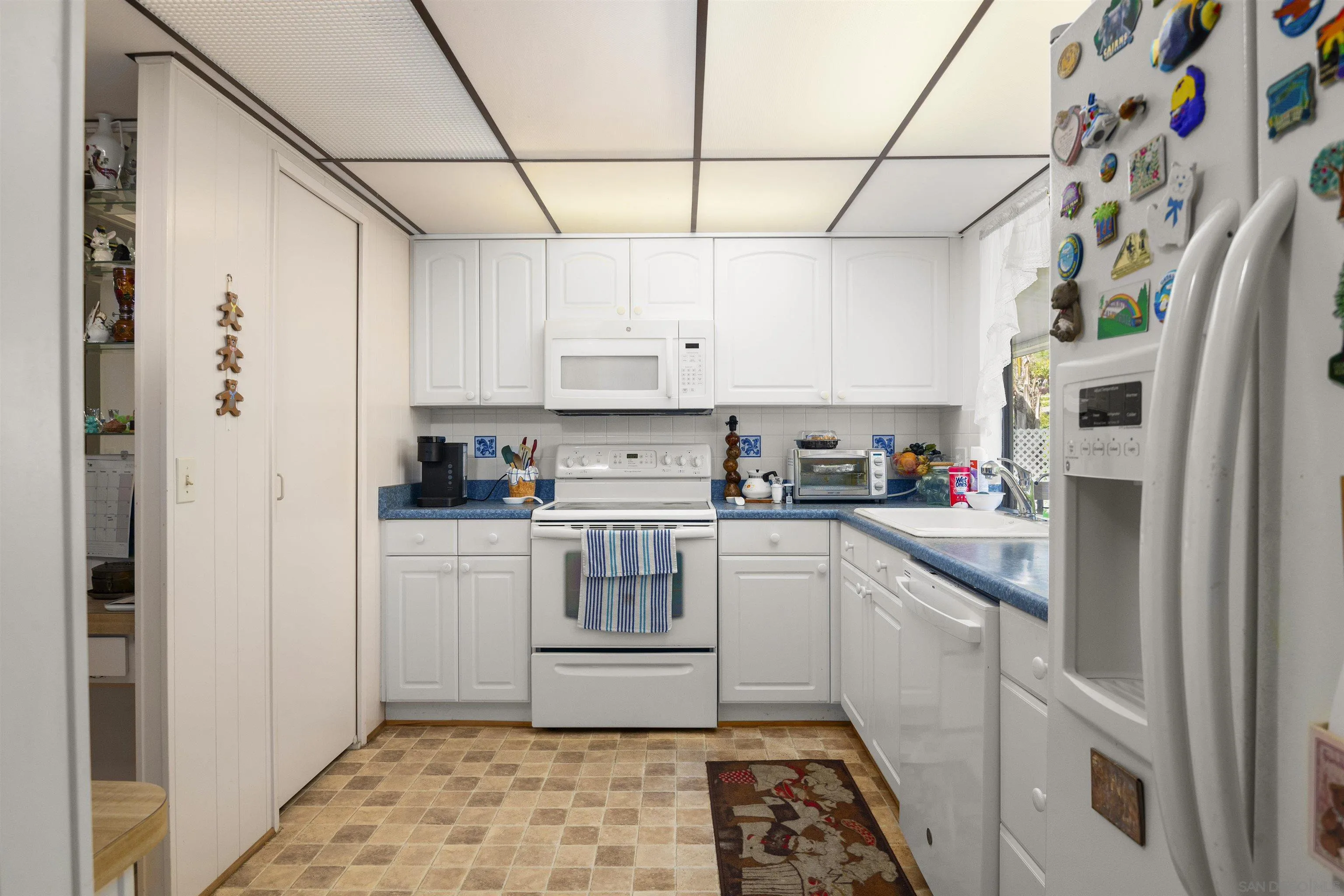 4747 Oak Crest Road, Unit 19 Fallbrook, CA 92028 - Photo 17 of 53 a kitchen with stainless steel appliances granite countertop a refrigerator and white cabinets