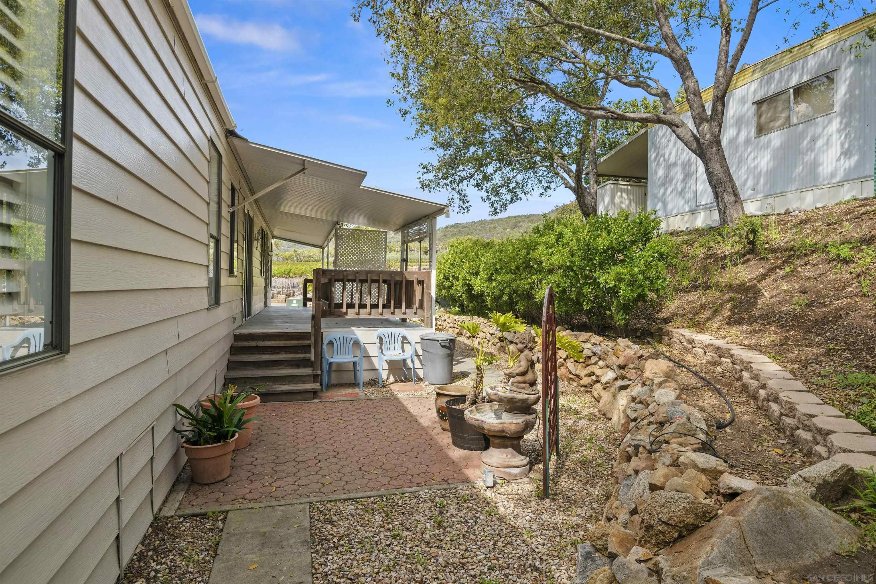 4747 Oak Crest Road, Unit 19 Fallbrook, CA 92028 - Photo 34 of 53 a view of a house with backyard and sitting area