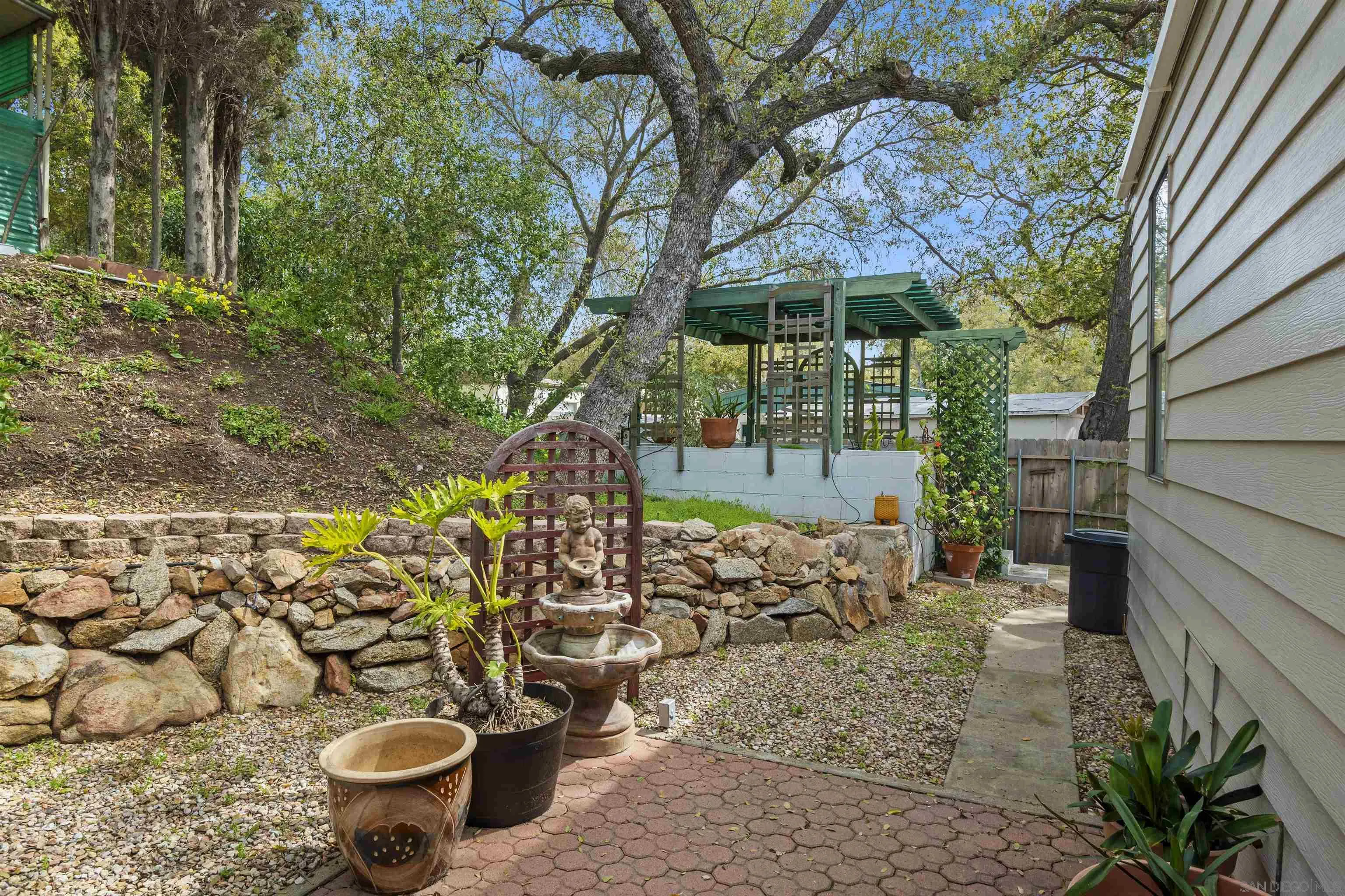 4747 Oak Crest Road, Unit 19 Fallbrook, CA 92028 - Photo 35 of 53 a view of a backyard with garden and patio