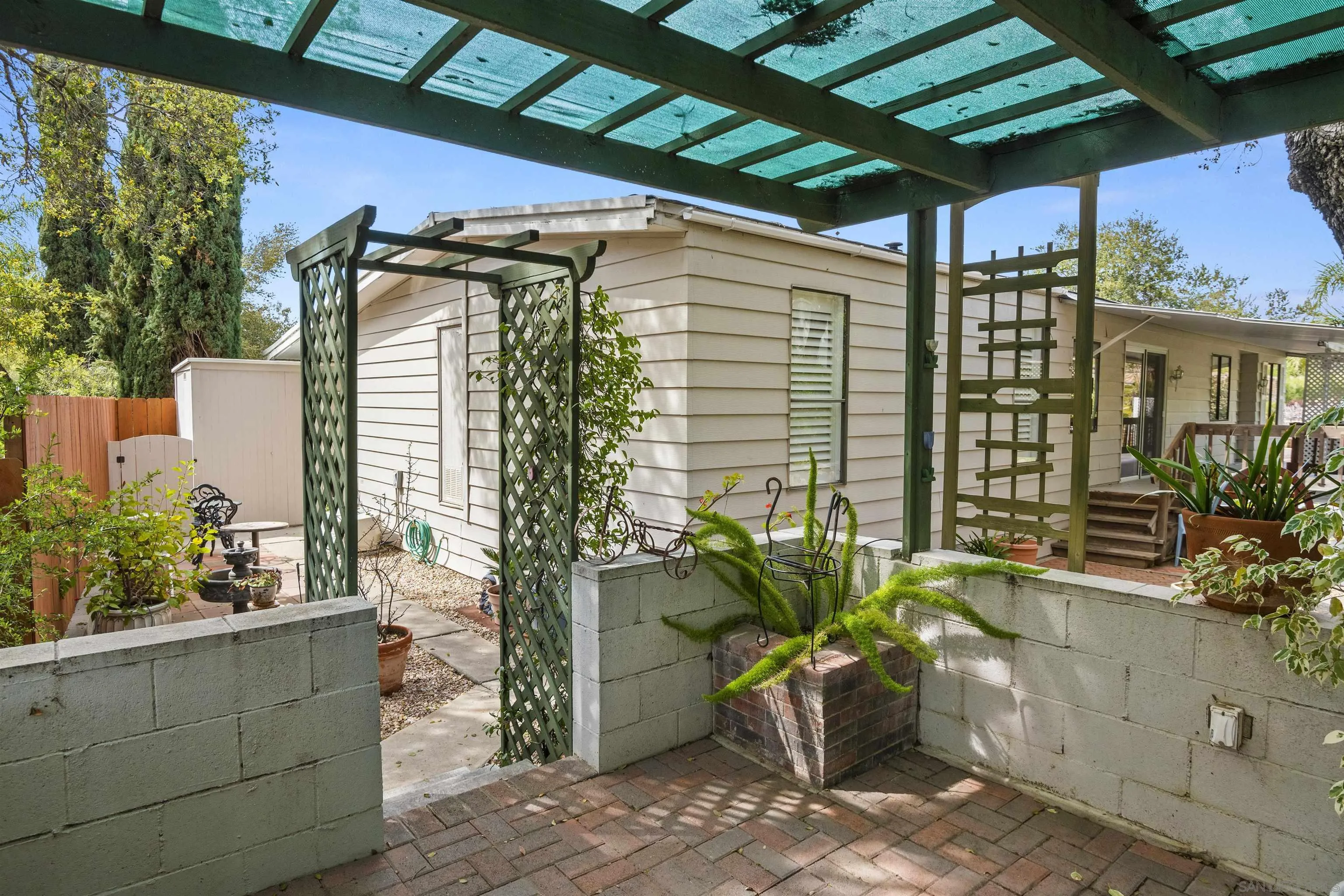 4747 Oak Crest Road, Unit 19 Fallbrook, CA 92028 - Photo 37 of 53 a potted plant sitting in front of a house