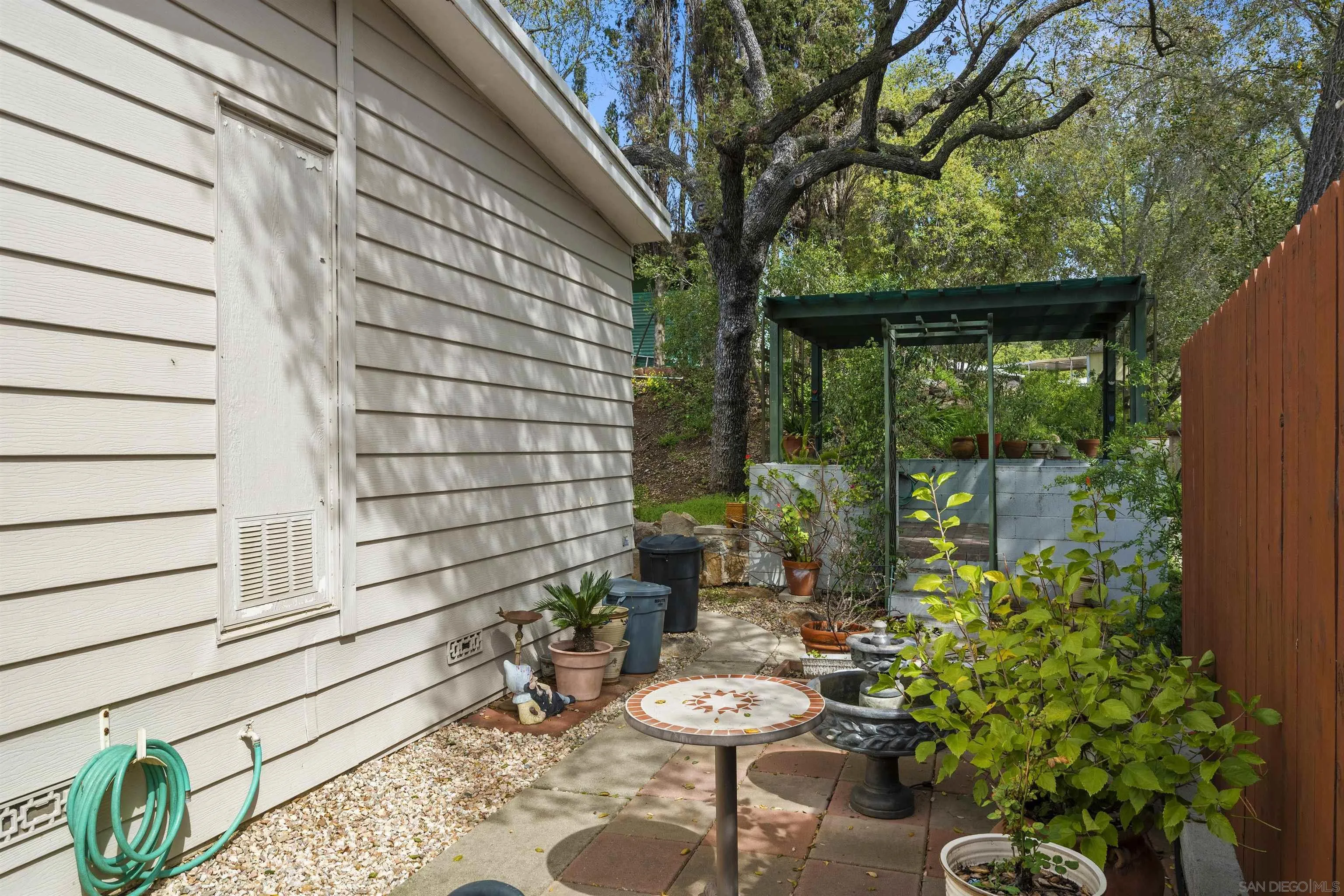 4747 Oak Crest Road, Unit 19 Fallbrook, CA 92028 - Photo 38 of 53 a view of a chair and table in backyard of the house