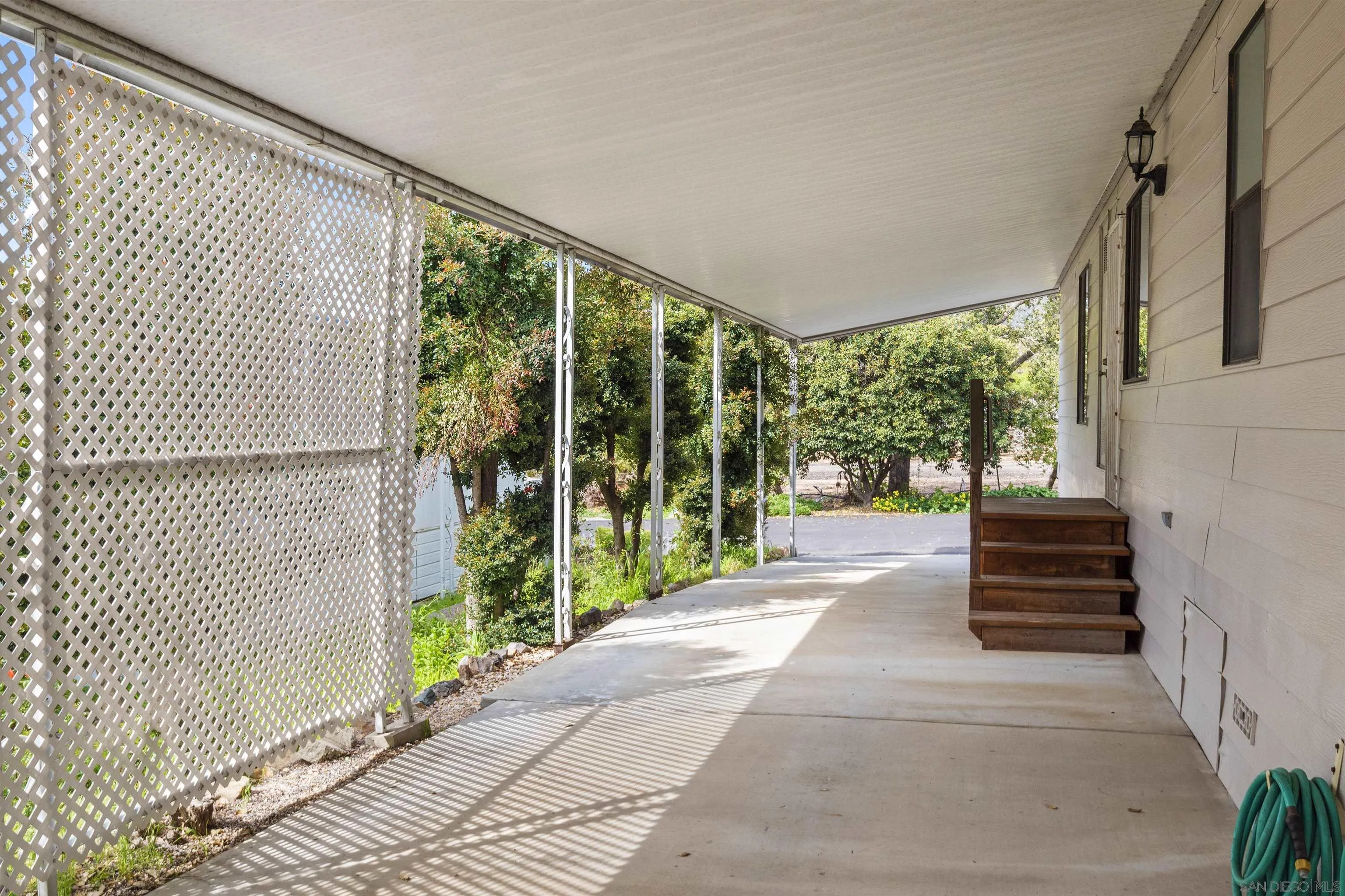 4747 Oak Crest Road, Unit 19 Fallbrook, CA 92028 - Photo 41 of 53 a porch with a garden view