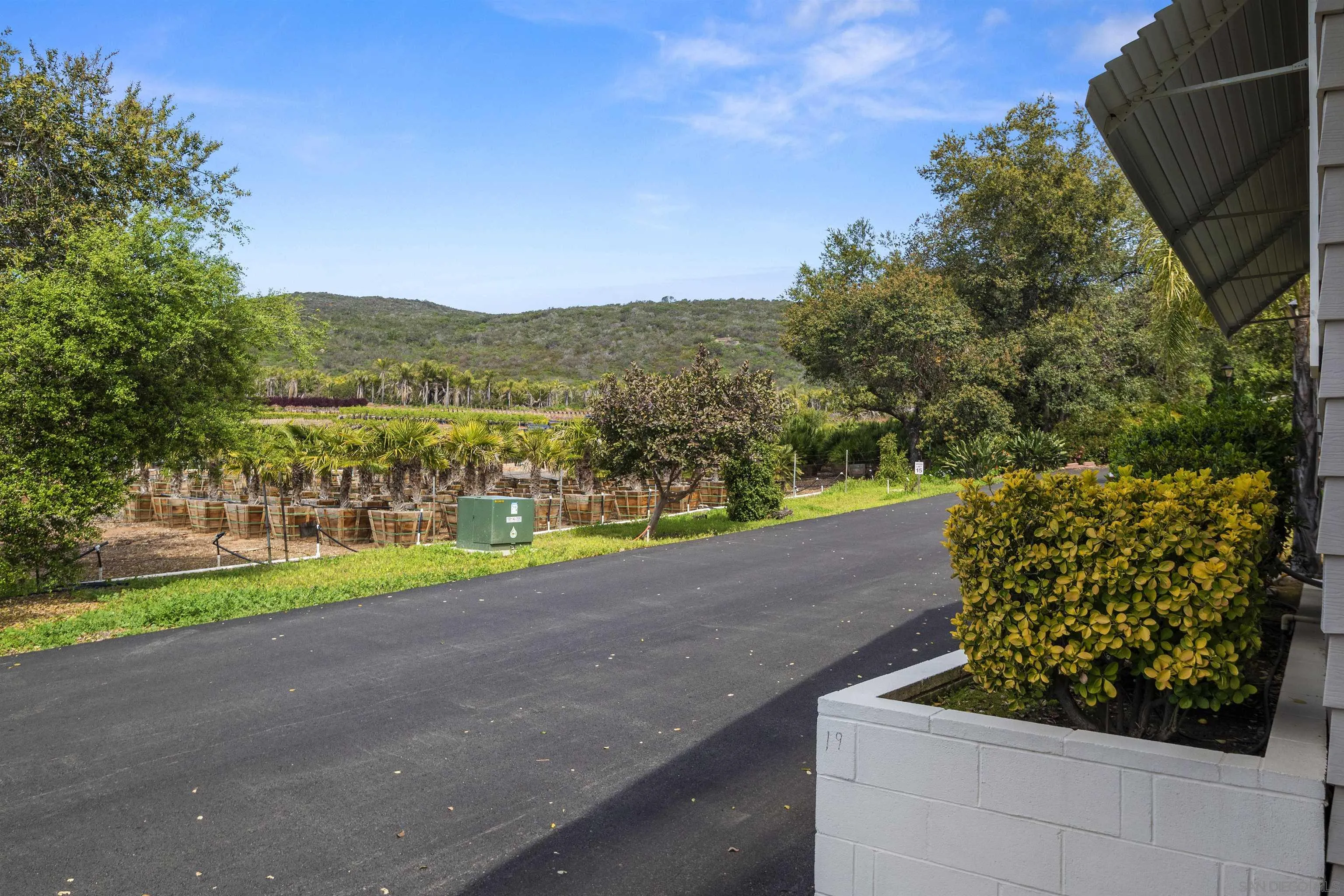4747 Oak Crest Road, Unit 19 Fallbrook, CA 92028 - Photo 43 of 53 a view of a road with a yard
