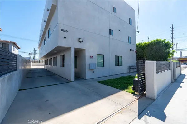 a view of white house with a yard