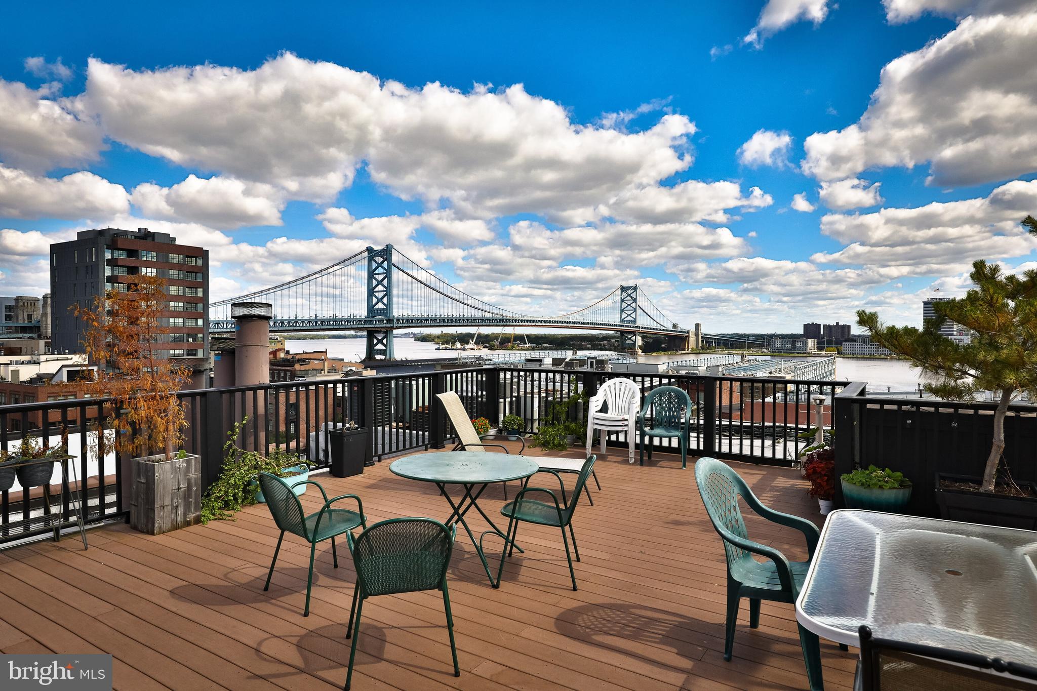 a view of a roof deck with furniture