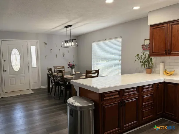 a kitchen with a sink a stove and cabinets