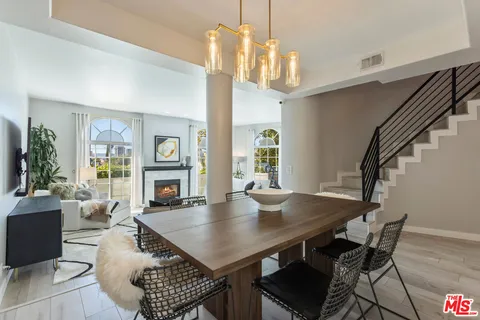 a view of a dining room with furniture and a chandelier