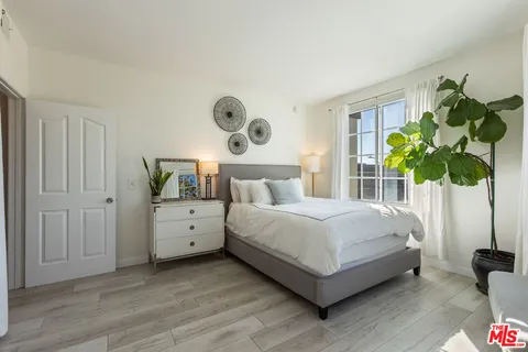 a bedroom with bed and a window