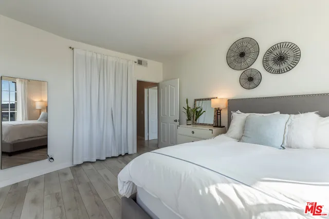 a living room with furniture potted plant and a large window