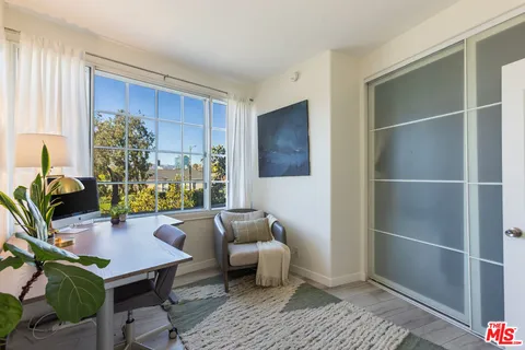 a view of a workspace with furniture and a potted plant