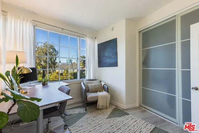 a view of a workspace with furniture and a potted plant