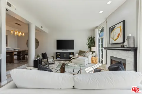 a living room with fireplace furniture and a flat screen tv