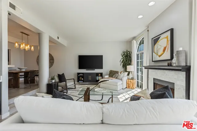 a living room with fireplace furniture and a flat screen tv