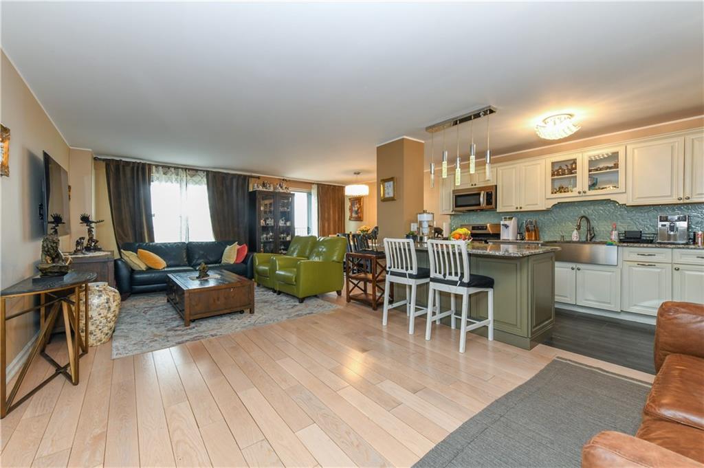 601 Surf Avenue, Unit 20J Brooklyn, NY 11224 - Photo 11 of 46 a living room with furniture kitchen view and a wooden floor