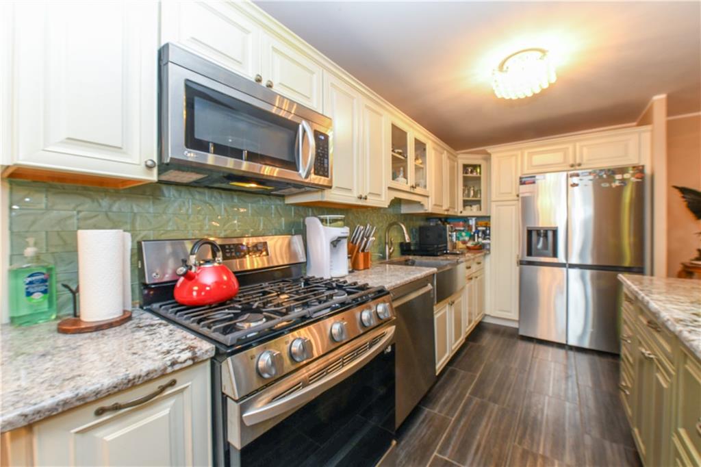 601 Surf Avenue, Unit 20J Brooklyn, NY 11224 - Photo 17 of 46 a kitchen with stainless steel appliances granite countertop a stove a sink and a microwave